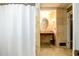 A well-lit bathroom vanity with a decorative mirror and travertine tile at 2272 Kimberley Way, Snellville, GA 30078