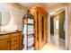 A view of the bathroom showing travertine tile, a vanity, a shelving unit, and a sauna at 2272 Kimberley Way, Snellville, GA 30078