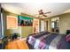 A spacious bedroom showcasing a ceiling fan and a television mounted on the olive-green wall at 2272 Kimberley Way, Snellville, GA 30078