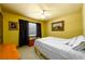Bedroom with yellow walls, black curtains, and an abundance of natural light at 2272 Kimberley Way, Snellville, GA 30078