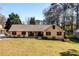 Charming brick ranch with a well-maintained lawn and mature trees, offering a classic suburban appeal at 2272 Kimberley Way, Snellville, GA 30078