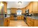 Well-lit kitchen with wood cabinets, stainless steel appliances, and hardwood floors at 2272 Kimberley Way, Snellville, GA 30078
