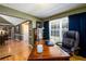Comfortable home office with built-in shelves, a large window, and hardwood flooring at 2272 Kimberley Way, Snellville, GA 30078