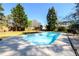 Well-maintained backyard pool with a clean, concrete deck and mature trees creating a cool retreat at 2272 Kimberley Way, Snellville, GA 30078