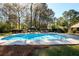 Sparkling in-ground swimming pool, surrounded by lush greenery offering a private and serene backyard oasis at 2272 Kimberley Way, Snellville, GA 30078