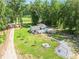 Aerial view showcases the home with its expansive yard and surrounding greenery, highlighting its private setting at 118 Raven Rd, Villa Rica, GA 30180