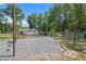 Large backyard with a fire pit and play area. The lot is mostly gravel and surrounded by trees at 118 Raven Rd, Villa Rica, GA 30180