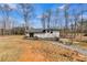 A view of the backyard with a deck and gravel path at 118 Raven Rd, Villa Rica, GA 30180