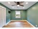 Well-lit bedroom with hardwood floors, closet, and natural light streaming through the window at 118 Raven Rd, Villa Rica, GA 30180