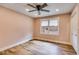 Empty bedroom with neutral walls, wood floors, a ceiling fan and bright window with natural light at 118 Raven Rd, Villa Rica, GA 30180