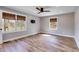 Bright bedroom featuring wood floors, windows with natural light, and a ceiling fan at 118 Raven Rd, Villa Rica, GA 30180