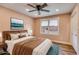 Comfortable bedroom featuring a bed, ceiling fan, and bright window with view of outside at 118 Raven Rd, Villa Rica, GA 30180