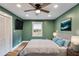 Cozy bedroom featuring a queen bed, light wood floors, and a ceiling fan at 118 Raven Rd, Villa Rica, GA 30180