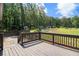 A view from the wooden deck overlooking the lush, tree-lined backyard, providing a relaxing outdoor living space at 118 Raven Rd, Villa Rica, GA 30180