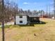 Well-maintained two-story home with a charming porch and a lush green lawn, set against a backdrop of mature trees at 118 Raven Rd, Villa Rica, GA 30180