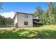Home exterior with manicured lawn and mature trees, blending charm and space at 118 Raven Rd, Villa Rica, GA 30180