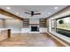 Bright living room features a fireplace, wood beam, and a large window with a view at 118 Raven Rd, Villa Rica, GA 30180