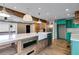 Open-concept living room with a wooden island, stainless steel appliances, and teal cabinets at 118 Raven Rd, Villa Rica, GA 30180