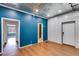 Bright room with hardwood floors and contrasting blue accent wall at 118 Raven Rd, Villa Rica, GA 30180