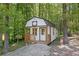 A charming shed with a porch nestled amongst the trees, offering a private escape at 118 Raven Rd, Villa Rica, GA 30180