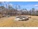 A spacious yard features a stone fire pit for outdoor enjoyment at 118 Raven Rd, Villa Rica, GA 30180
