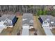 A daytime aerial view of the home's exterior, roof, driveway and landscaping at 1659 Hay Patch Ln, Loganville, GA 30052