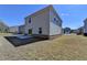 The home has a spacious backyard featuring a concrete patio and a side view of the home at 1659 Hay Patch Ln, Loganville, GA 30052