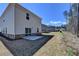 An exterior view showing a concrete patio area in the backyard with sliding glass doors at 1659 Hay Patch Ln, Loganville, GA 30052