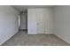 Spacious bedroom featuring neutral walls, plush carpeting, and two doorways at 1659 Hay Patch Ln, Loganville, GA 30052
