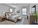 The primary bedroom is decorated in neutral colors, a modern bed, and lots of light at 1659 Hay Patch Ln, Loganville, GA 30052