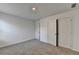 A bright bedroom with neutral carpet and a closet with double doors at 1659 Hay Patch Ln, Loganville, GA 30052