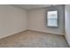Comfortable bedroom with a bright window, neutral walls, and plush carpeting at 1659 Hay Patch Ln, Loganville, GA 30052