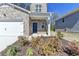 Close up of a charming home exterior featuring a well-maintained yard and elegant front door at 1659 Hay Patch Ln, Loganville, GA 30052