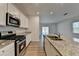 Modern kitchen with stainless steel appliances, granite countertops, and a large island at 1659 Hay Patch Ln, Loganville, GA 30052