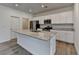 The kitchen is equipped with granite countertops, stainless appliances, and a large island at 1659 Hay Patch Ln, Loganville, GA 30052