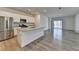 Open-concept kitchen with stainless steel appliances, granite countertops, and hardwood flooring at 1659 Hay Patch Ln, Loganville, GA 30052