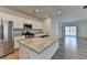 Modern kitchen featuring an island, stainless steel appliances, and a view of the living area at 1659 Hay Patch Ln, Loganville, GA 30052