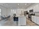 Modern kitchen featuring an island, stainless steel appliances, and a view of the dining area at 1659 Hay Patch Ln, Loganville, GA 30052