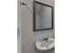 Powder room with pedestal sink, a mirror, and a towel ring at 1659 Hay Patch Ln, Loganville, GA 30052