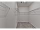 Walk-in closet featuring carpet, white walls, and metal wire shelving for ample storage at 1659 Hay Patch Ln, Loganville, GA 30052