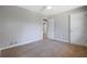 Bedroom showcasing neutral walls, carpet, and a doorway to an ensuite bathroom at 2522 Brentwood Ct, Decatur, GA 30032