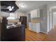 An angle view of the kitchen showing the cabinets, flooring, and stainless steel refrigerator at 2522 Brentwood Ct, Decatur, GA 30032