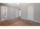 Main bedroom showing access to the bathroom, gray walls, neutral carpet, and white trim at 2522 Brentwood Ct, Decatur, GA 30032