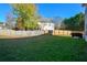 Large backyard featuring a wooden fence and green grass at 3820 Mast Nw Ct, Kennesaw, GA 30144