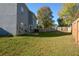 Large backyard with a patio, grill, and a wooden fence at 3820 Mast Nw Ct, Kennesaw, GA 30144