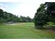 Baseball field with a backstop and surrounding green space in Legacy Park community at 3820 Mast Nw Ct, Kennesaw, GA 30144