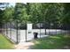 Community basketball court with multiple hoops, benches, and lush surroundings in Legacy Park at 3820 Mast Nw Ct, Kennesaw, GA 30144