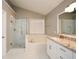 Bright bathroom boasts a glass enclosed shower, garden tub, white cabinets, and granite countertops at 3820 Mast Nw Ct, Kennesaw, GA 30144