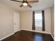 Bedroom with dark hardwood flooring, ceiling fan, and window with curtains at 3820 Mast Nw Ct, Kennesaw, GA 30144