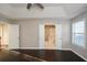 Bright bedroom featuring high ceiling, hardwood floors and open door to adjoining bath at 3820 Mast Nw Ct, Kennesaw, GA 30144